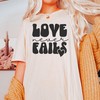 Inspirational Love Never Fails Christian T-Shirt with Faith Design